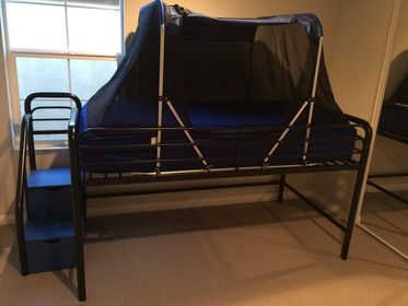 The Safety Sleeper on a metal loft style bed frame